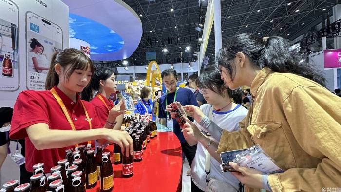 第四届消博会上，观众了解进口展品。人民网记者 符武平摄
